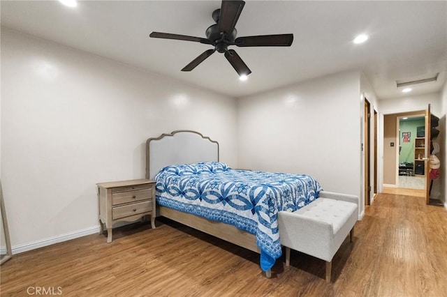 bedroom featuring hardwood / wood-style floors and ceiling fan