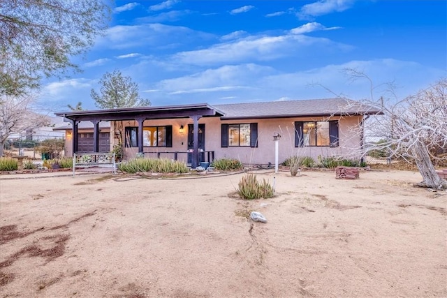 single story home featuring covered porch