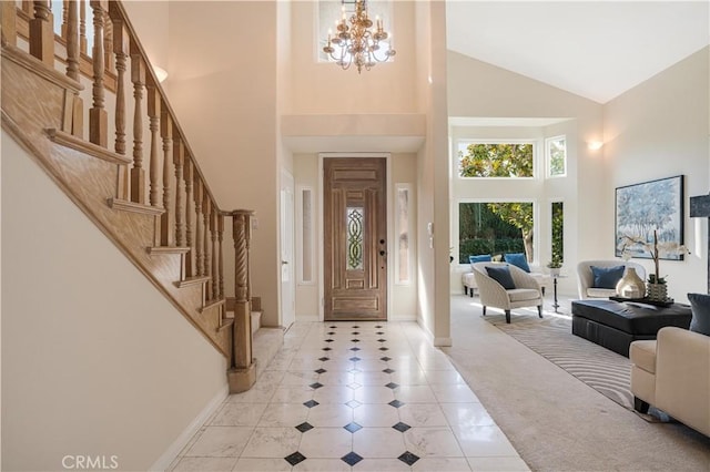 foyer featuring a towering ceiling, a chandelier, and light tile patterned floors