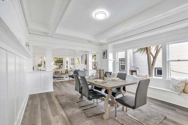 dining space with beamed ceiling, wood-type flooring, and coffered ceiling