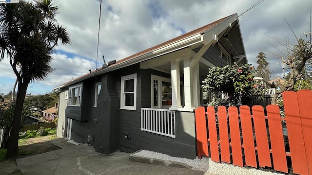 view of side of property with covered porch