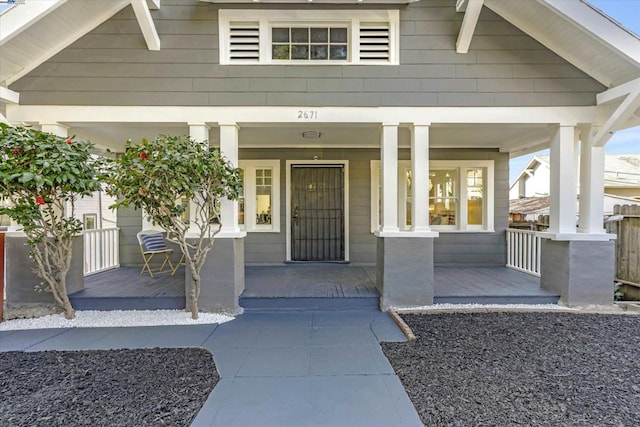 view of exterior entry featuring a porch