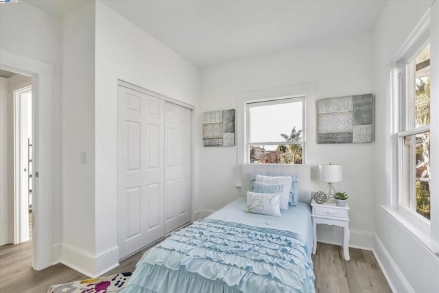 bedroom featuring a closet and light wood-type flooring