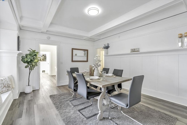 dining area with beamed ceiling and hardwood / wood-style flooring