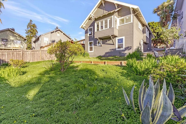 rear view of house featuring a yard