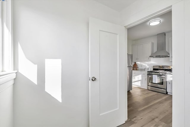 corridor with light hardwood / wood-style flooring