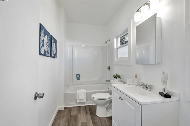 full bathroom featuring hardwood / wood-style flooring, bathing tub / shower combination, vanity, and toilet