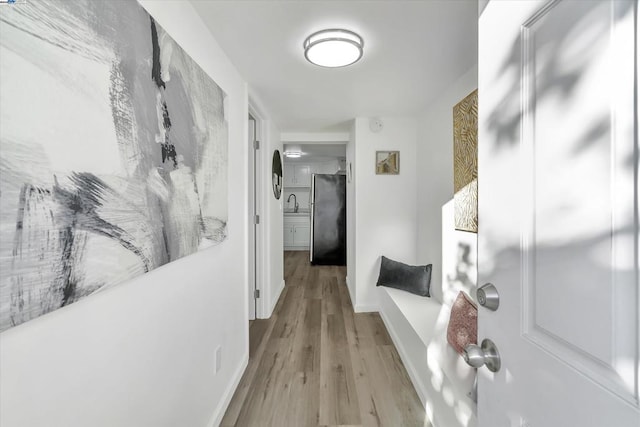 hall featuring sink and light hardwood / wood-style floors