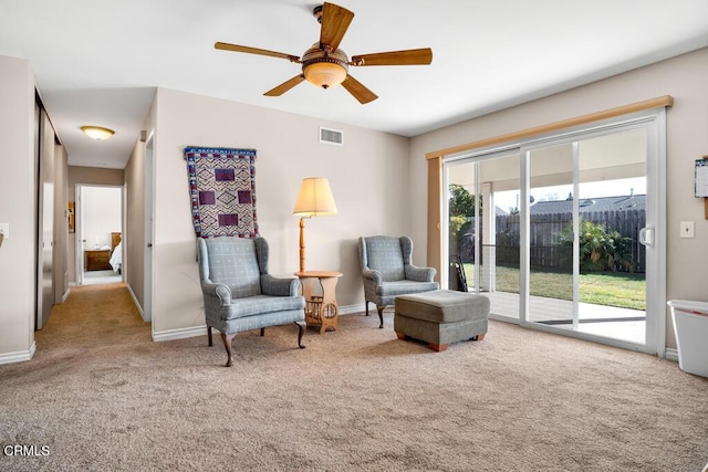 sitting room featuring ceiling fan and light colored carpet