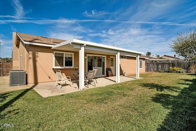 rear view of property featuring a patio, a lawn, and central air condition unit