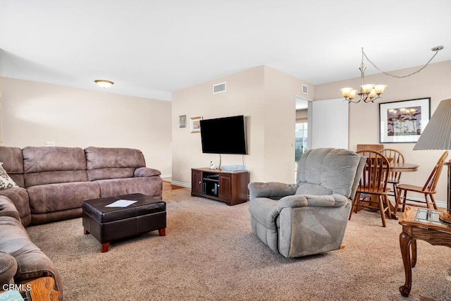 carpeted living room with an inviting chandelier