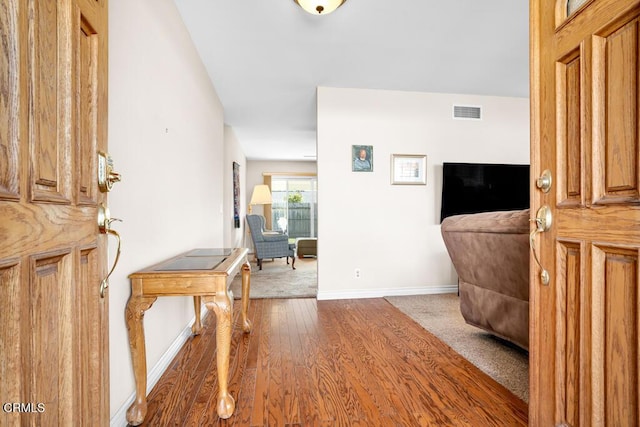 foyer entrance with dark hardwood / wood-style floors