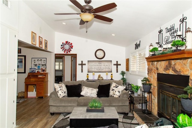 living room featuring lofted ceiling, dark hardwood / wood-style flooring, a fireplace, and ceiling fan