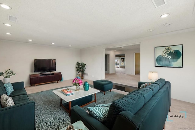 carpeted living room featuring ornamental molding