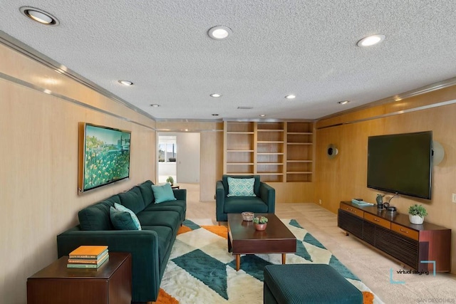 living room with crown molding, wooden walls, and a textured ceiling