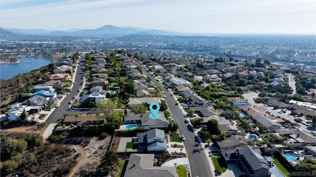 drone / aerial view featuring a water and mountain view