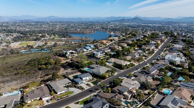 drone / aerial view with a water and mountain view