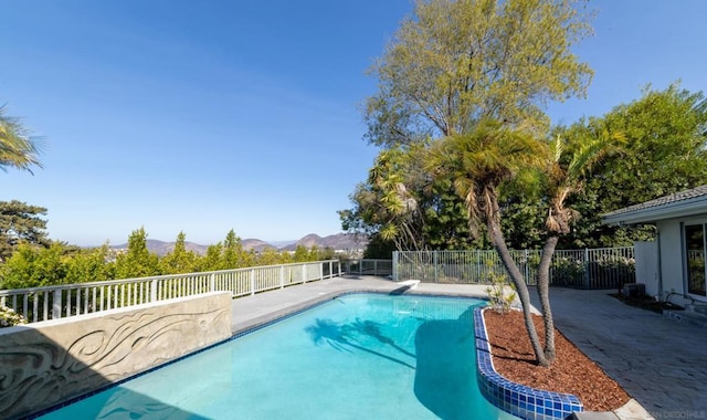 view of swimming pool featuring a mountain view and a diving board