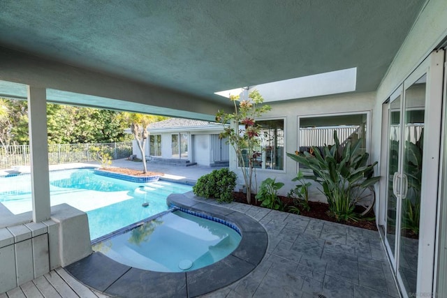 view of pool featuring a hot tub and a patio