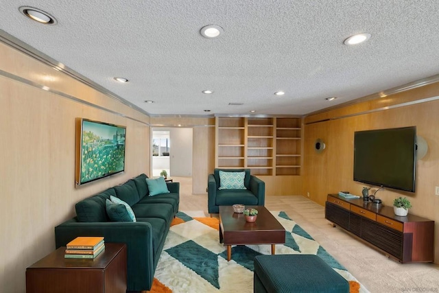 carpeted living room featuring ornamental molding, wooden walls, and a textured ceiling