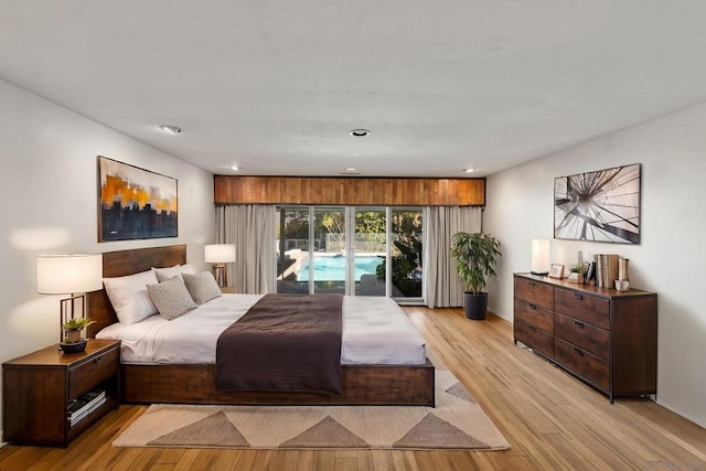 bedroom with access to exterior and light wood-type flooring