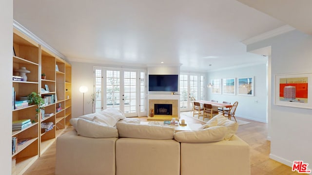 living room with crown molding, french doors, and light wood-type flooring