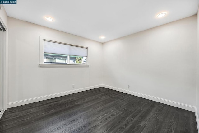 unfurnished room featuring dark hardwood / wood-style flooring