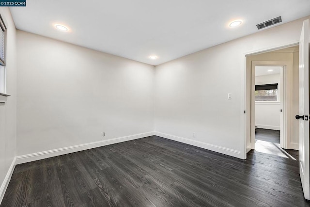 spare room featuring dark hardwood / wood-style floors