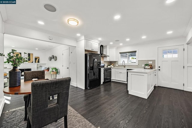 kitchen with tasteful backsplash, white cabinetry, black appliances, dark wood-type flooring, and wall chimney exhaust hood