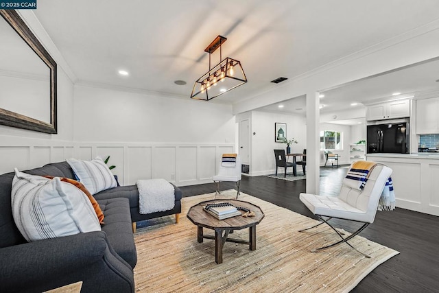 living room featuring hardwood / wood-style flooring and ornamental molding