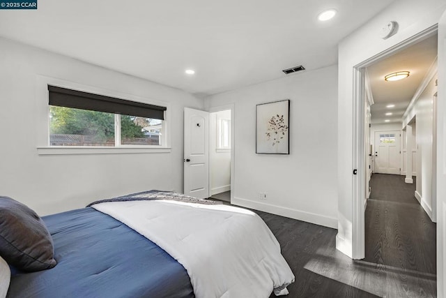 bedroom with dark wood-type flooring