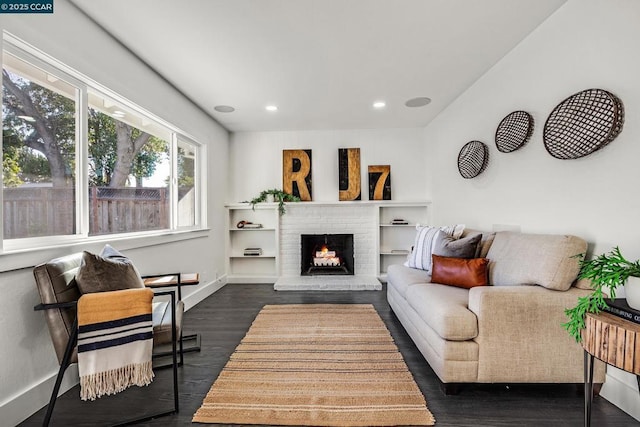 living room featuring a fireplace and dark hardwood / wood-style floors