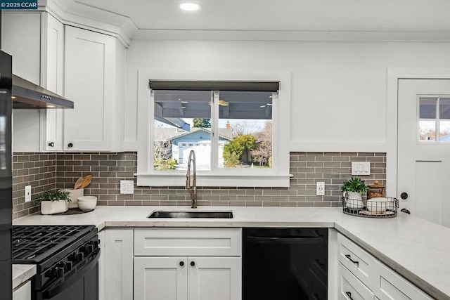 kitchen with white cabinetry, sink, tasteful backsplash, and black appliances