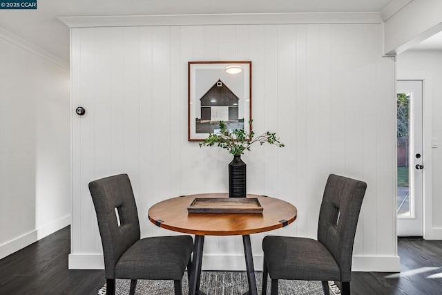 dining space featuring dark hardwood / wood-style flooring, crown molding, and a healthy amount of sunlight