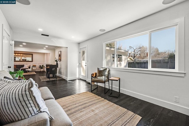 living room with dark hardwood / wood-style flooring