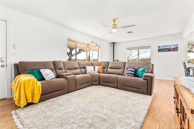 living room featuring ceiling fan and light hardwood / wood-style floors