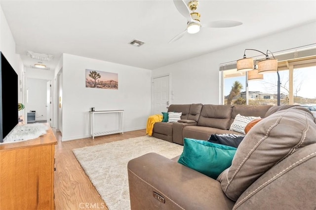 living room featuring ceiling fan and light hardwood / wood-style floors