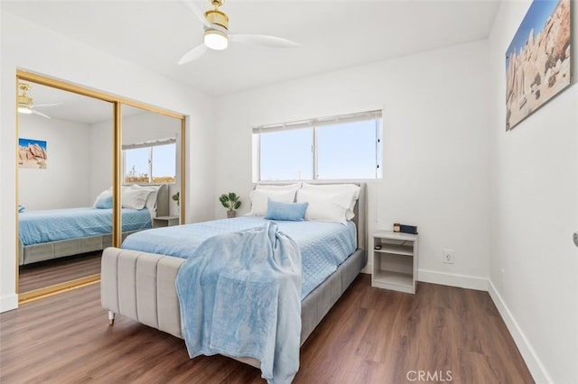 bedroom with ceiling fan, a closet, baseboards, and wood finished floors