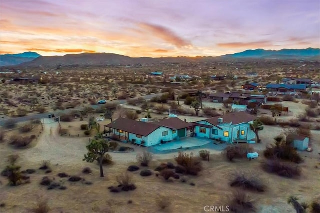 aerial view at dusk featuring a mountain view