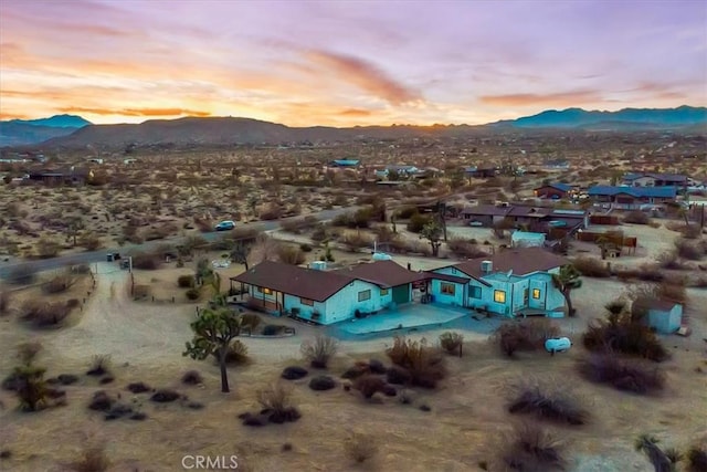 aerial view at dusk with a mountain view and a desert view