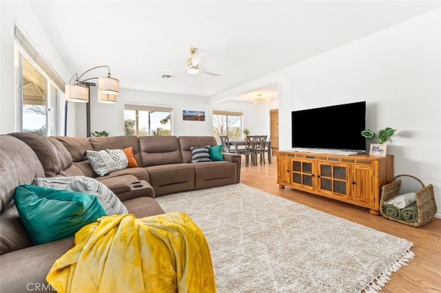 living room with hardwood / wood-style floors and ceiling fan