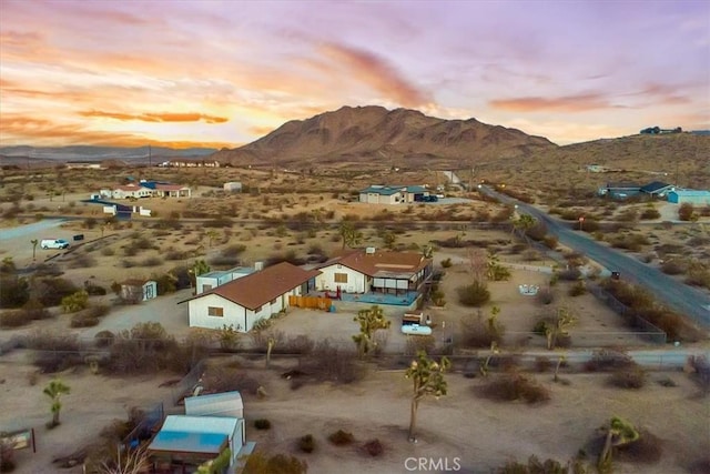 aerial view at dusk with a mountain view and a desert view