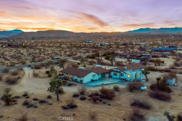 aerial view at dusk with view of desert and a mountain view