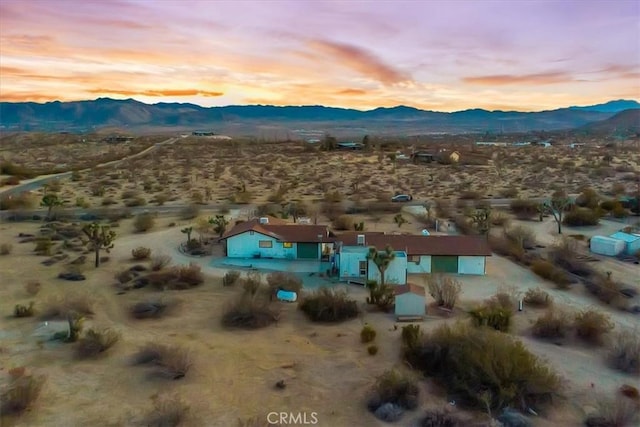 aerial view at dusk featuring a mountain view