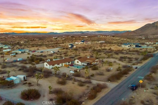 birds eye view of property with view of desert and a mountain view