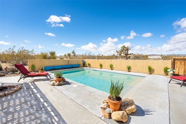 view of swimming pool featuring a fenced backyard, a fenced in pool, and a patio