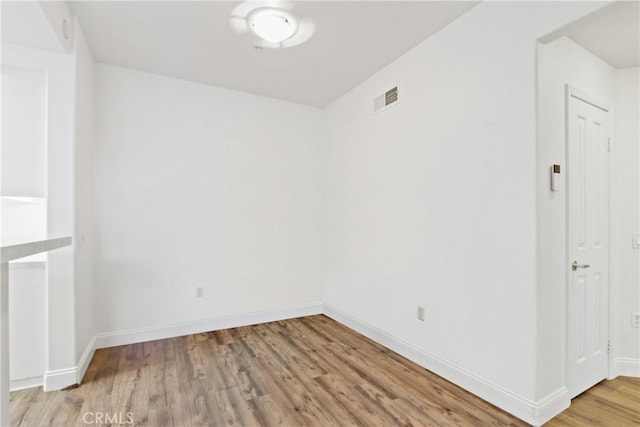 spare room with wood-type flooring