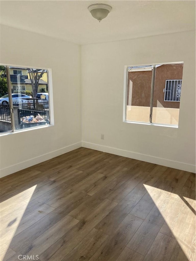 unfurnished room featuring hardwood / wood-style flooring and plenty of natural light