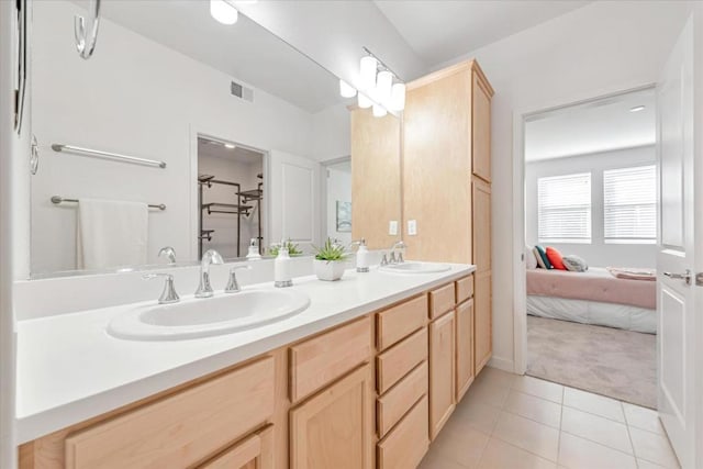 bathroom with tile patterned floors and vanity