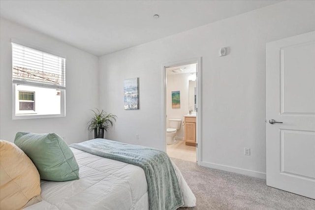 carpeted bedroom featuring ensuite bath